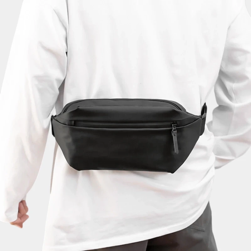 The Aviemore - The Aviemore nylon bum bag in black, worn round the waist The Aviemore nylon bum bag in black, worn round the waist