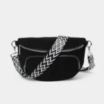 The Ilkley corduroy bum bag in black with its black and white geometric-pattern strap, front view