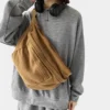 The Keswick - The Keswick canvas bum bag in brown, worn across the body The Keswick canvas bum bag in brown, worn across the body