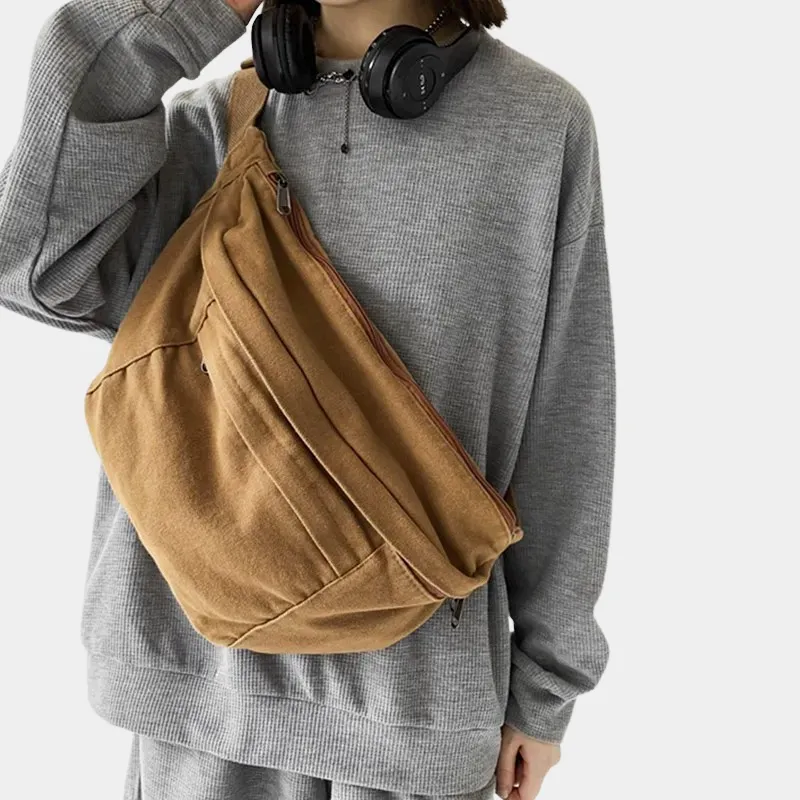 The Keswick - The Keswick canvas bum bag in brown, worn across the body The Keswick canvas bum bag in brown, worn across the body