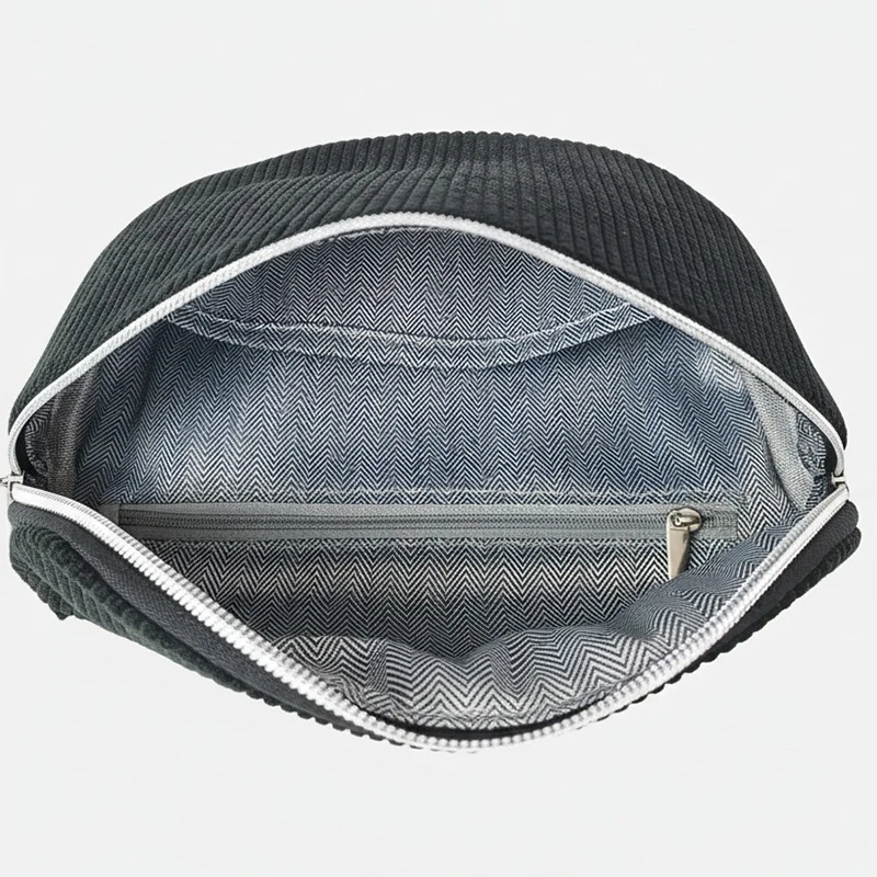 The Malton corduroy bum bag in black, open to show the inside