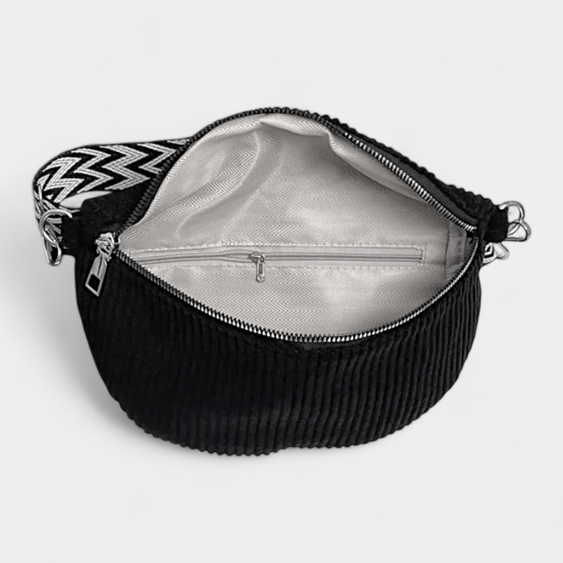 The Skipton corduroy bum bag in black, open to show the inside