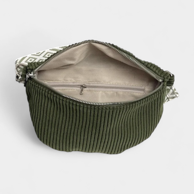 The Skipton corduroy bum bag in green, open to show the inside