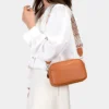 The Tetbury leather crossbody bag in brown, worn across the body