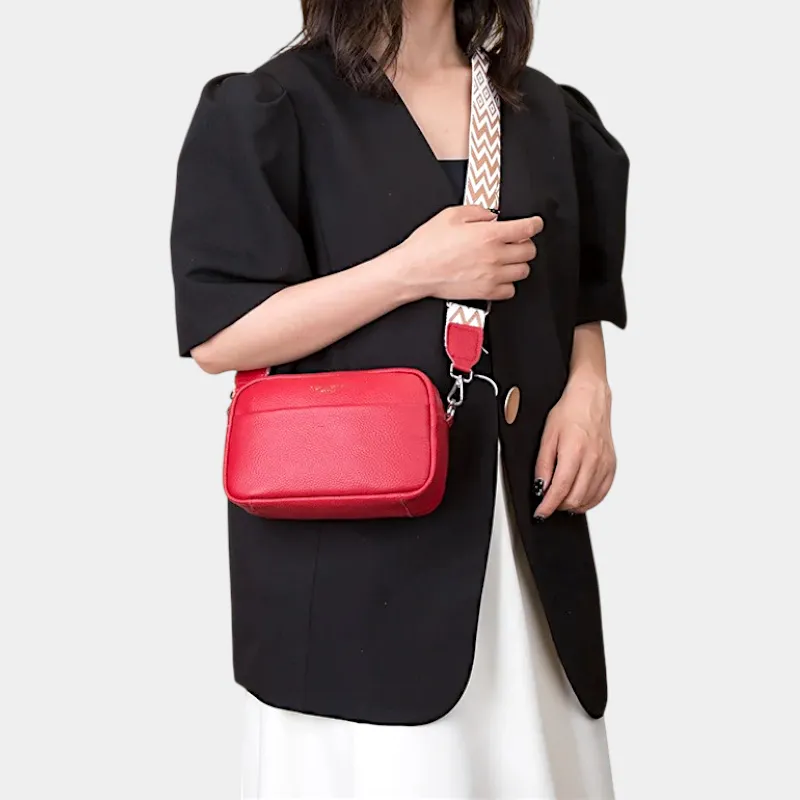 The Tetbury leather crossbody bag in red, worn across the body